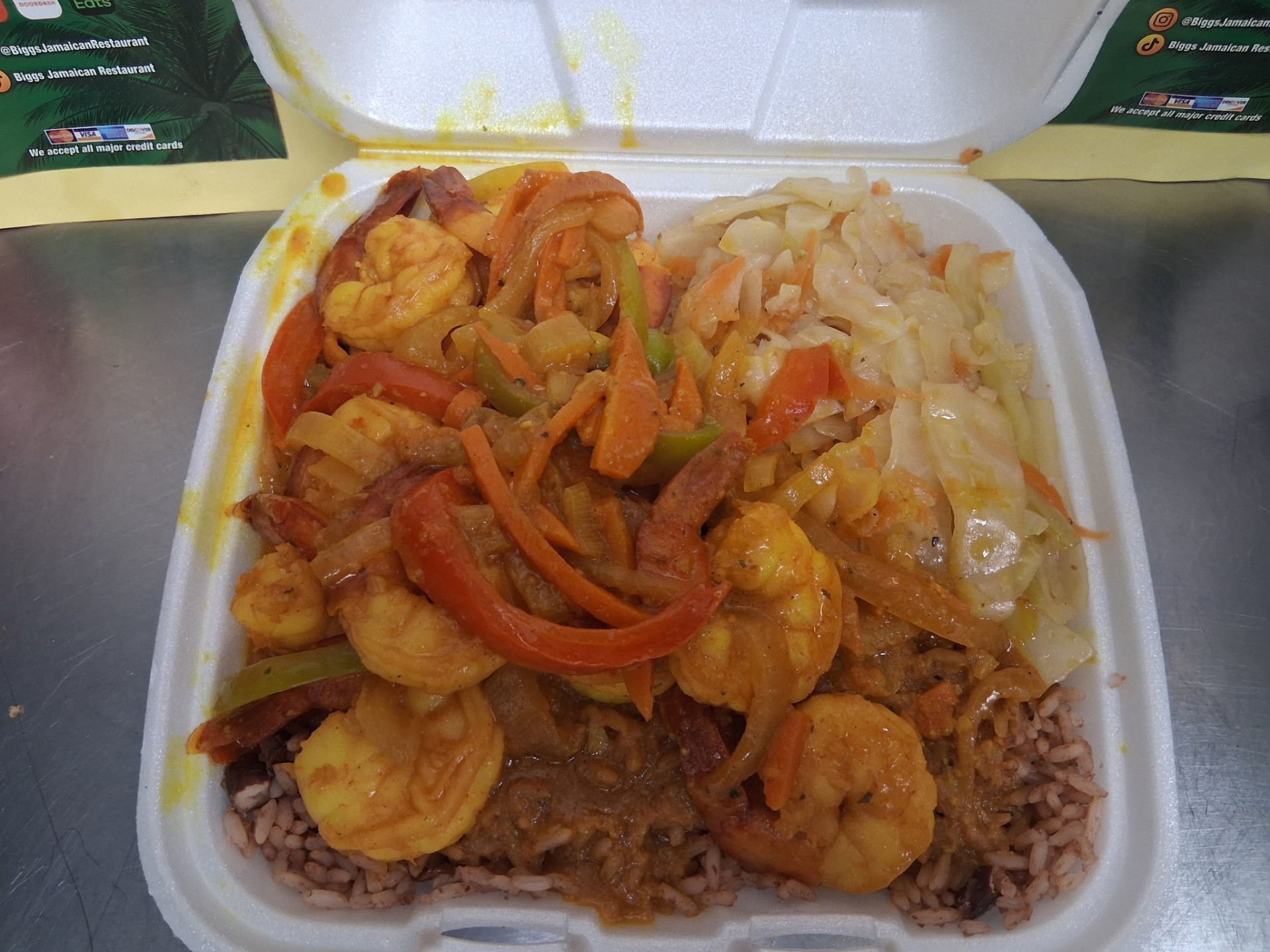 Curry shrimp with steamed cabbage and rice and peas